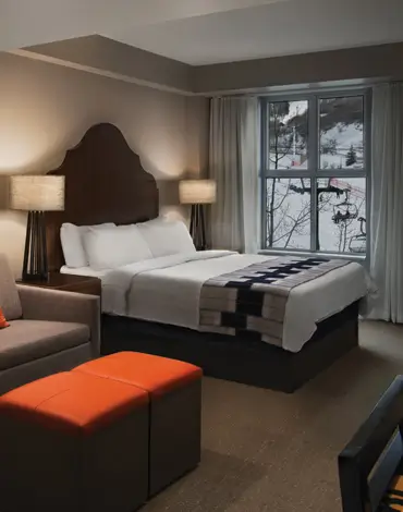 Villa bedroom with sofa, ottoman and bed