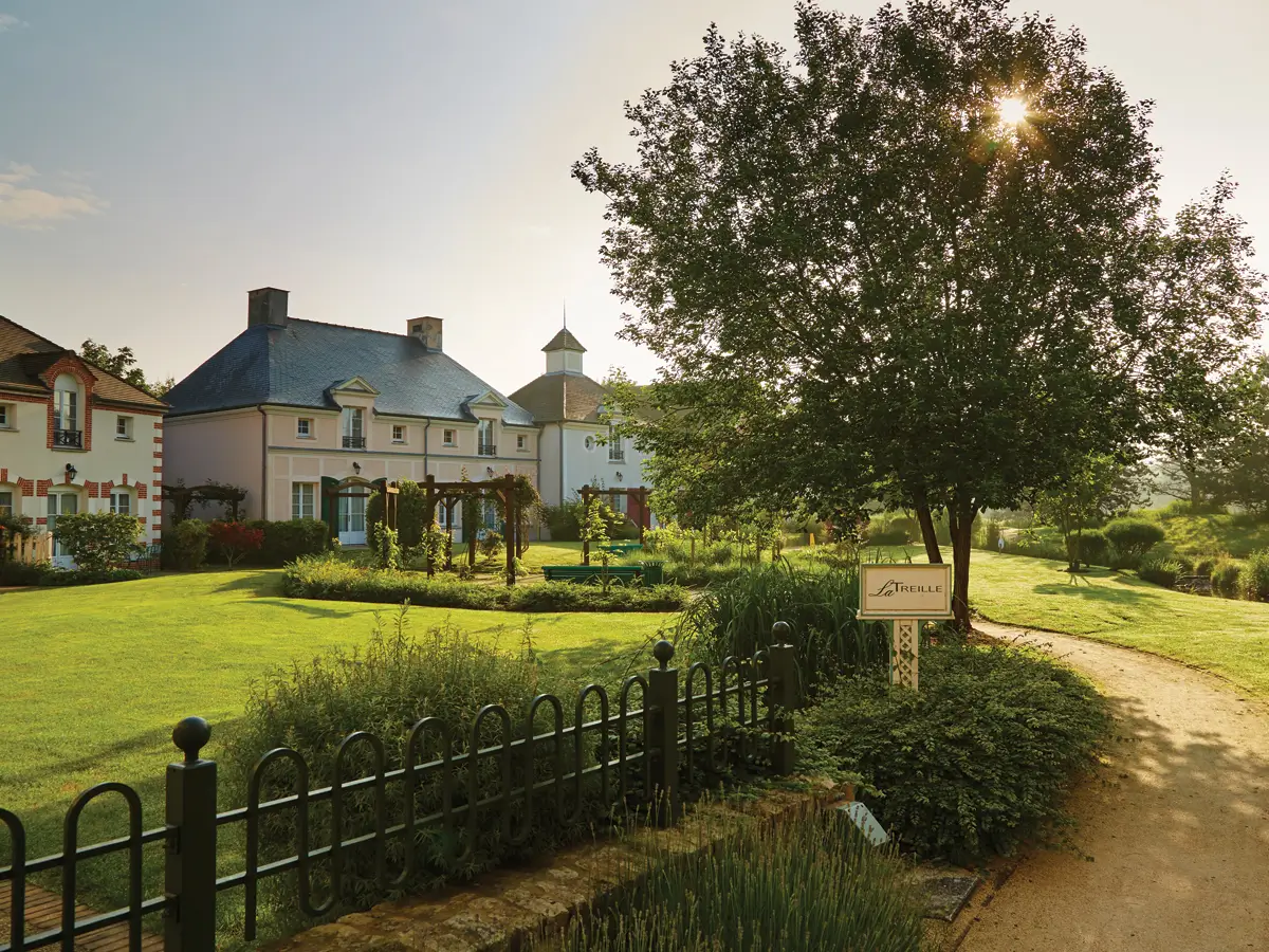Marriott's Village d'Ile-de-France, Bailly-Romainvilliers near Paris, France resort exterior with serene landscape featuring a well-maintained garden and beautiful architecture.