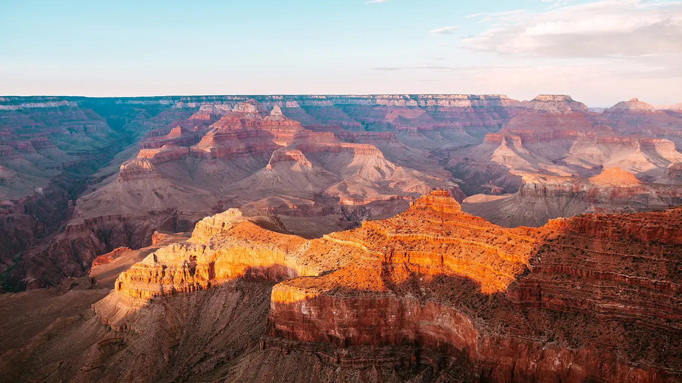 Stunning view of the Grand Canyon at sunset, showcasing the vibrant colors of the rock