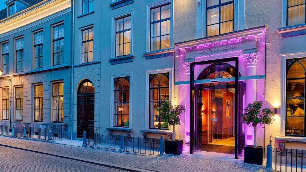 Hotel Nassau Breda, Autograph Collection exterior entrance lit with pink lights at dusk