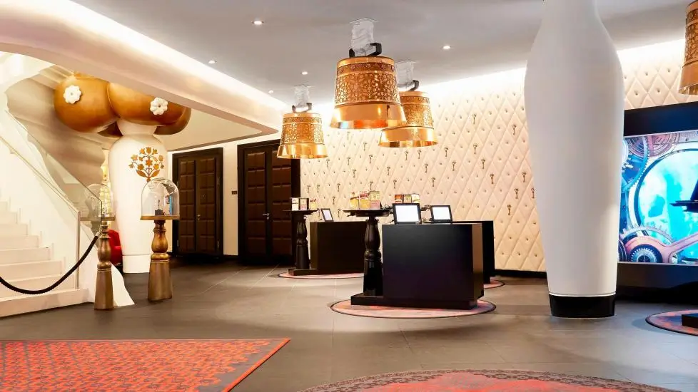 Kameha Grand Zurich, Autograph Collection interior lobby with dramatic gold accents and lights