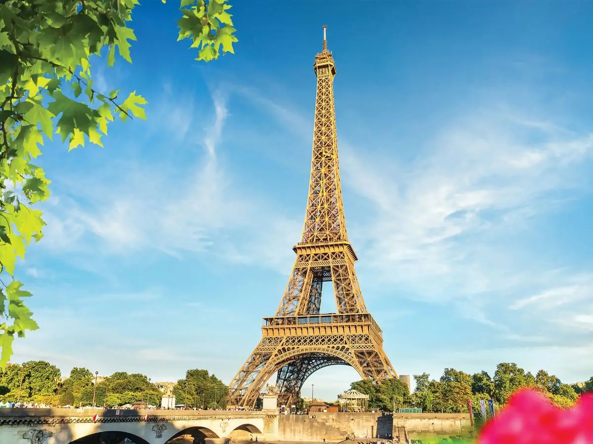 Eiffel Tower with a bridge and trees in Paris