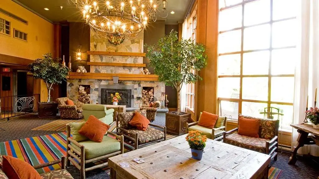 Cozy lobby interior of Embarc Whistler with a fireplace and comfortable seating.