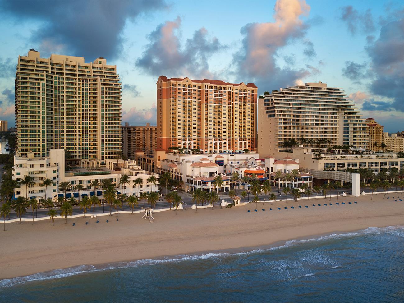 Aerial of exterior of Beach Place Towers along the coast from the ocean side