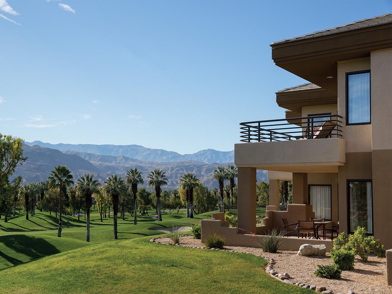 Exterior Marriott's Desert Springs Villas resort timeshare with Harbor date palms, a golf course and mountains the background