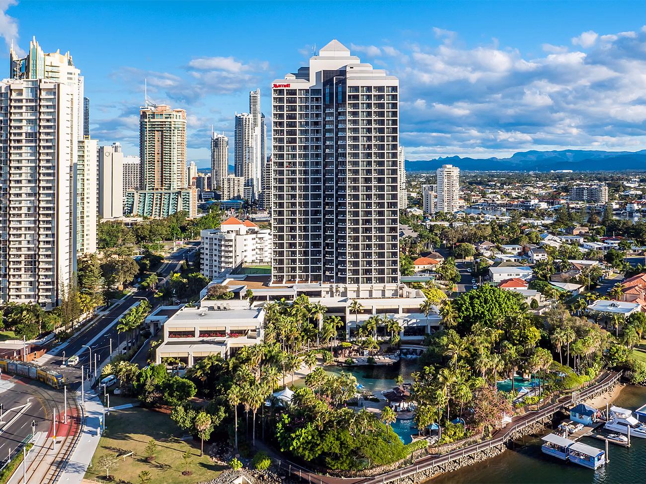Aerial of exterior of Marriott Vacation Club at Surfers Paradise resort timeshare with waterway and boat docks in foreground